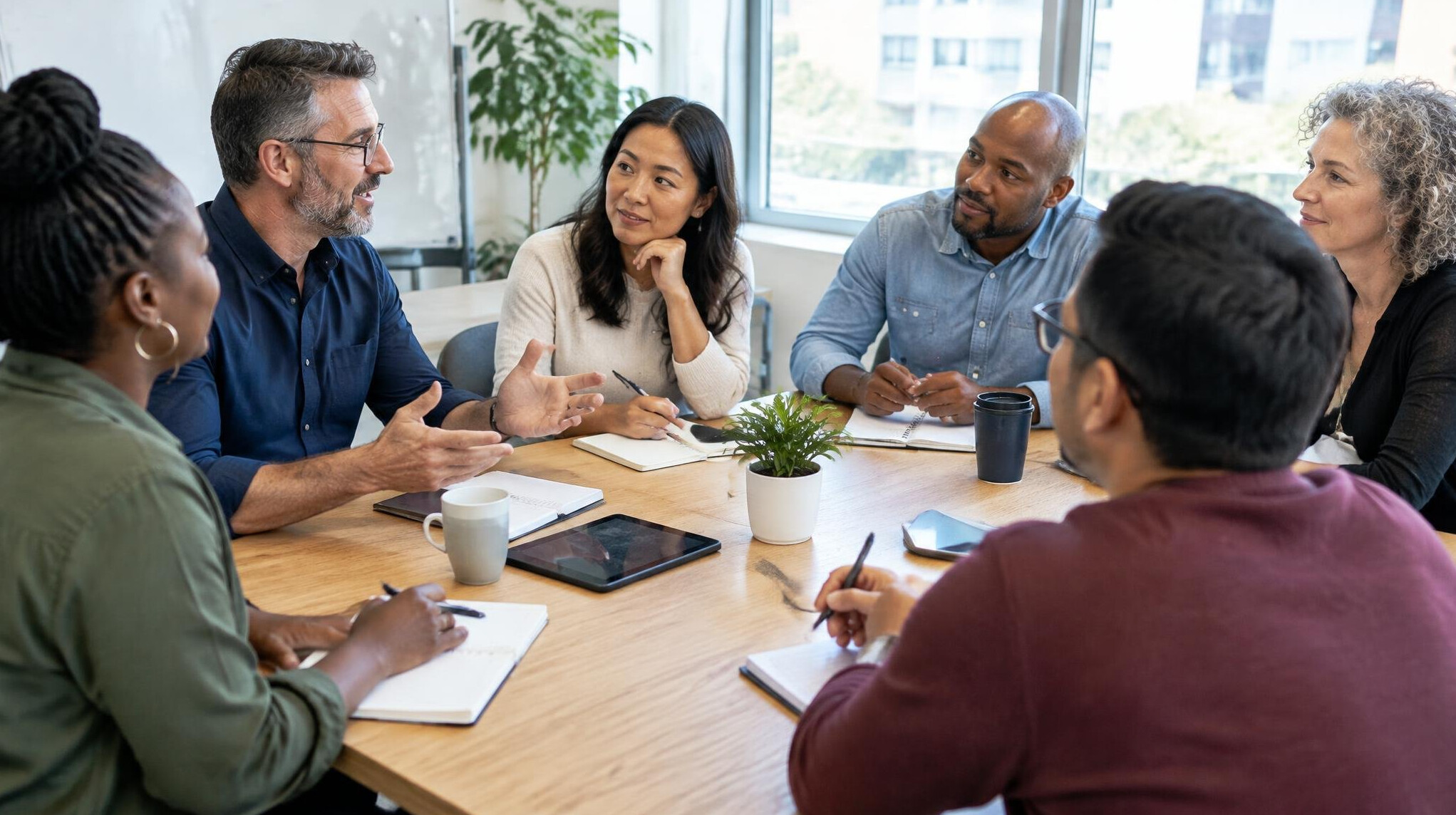 Diverse group of adults participating in a focus group discussion around a table